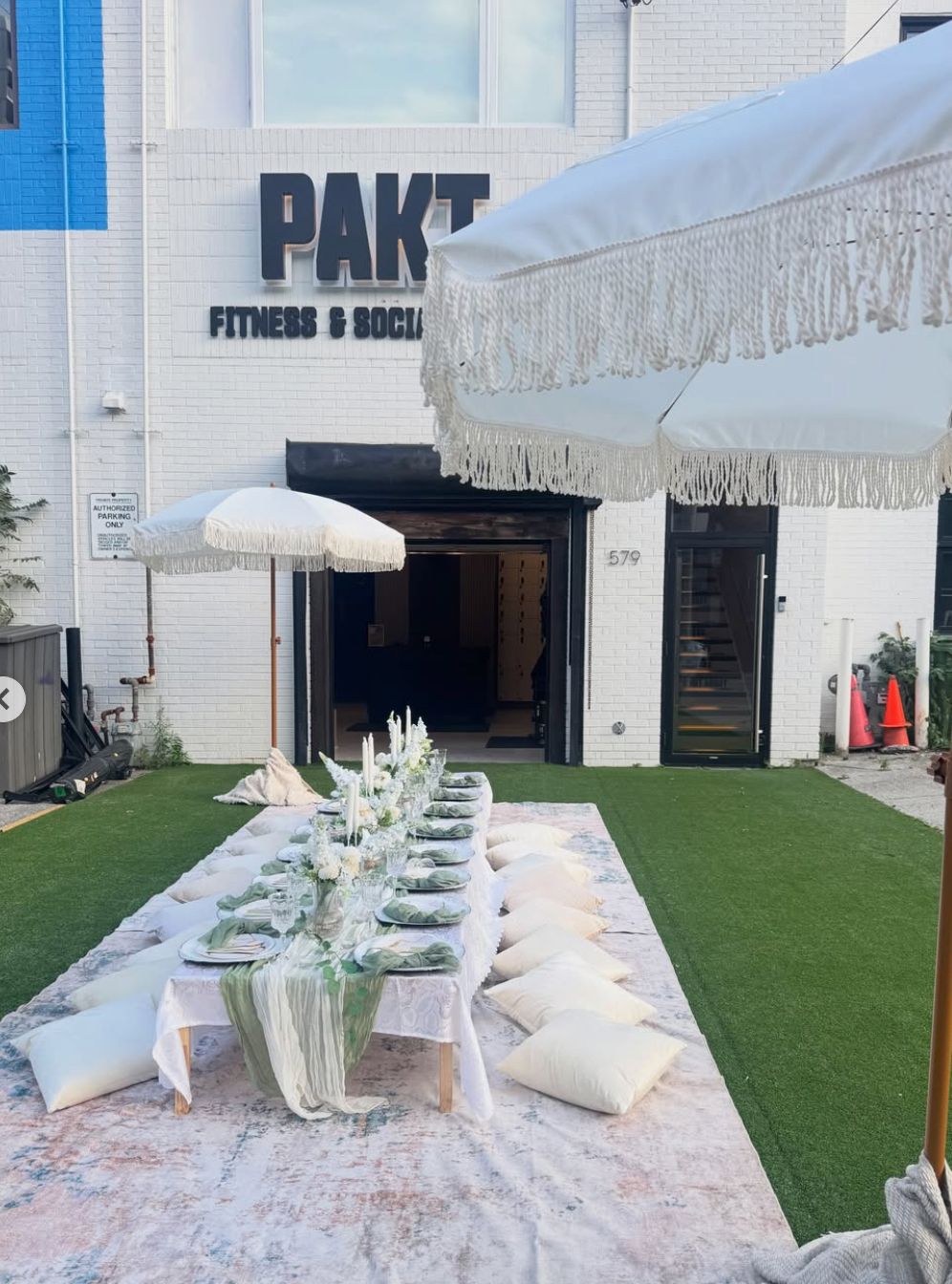 Sage and ivory long table styled at a venue